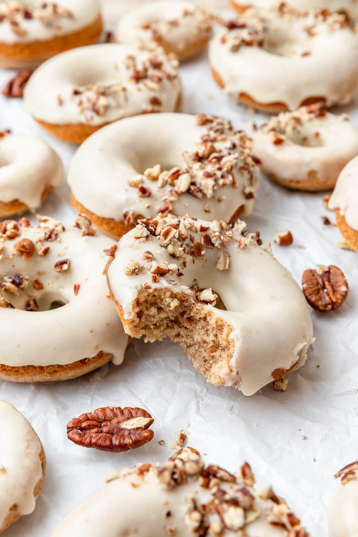 brown butter maple pecan donuts with maple glaze.