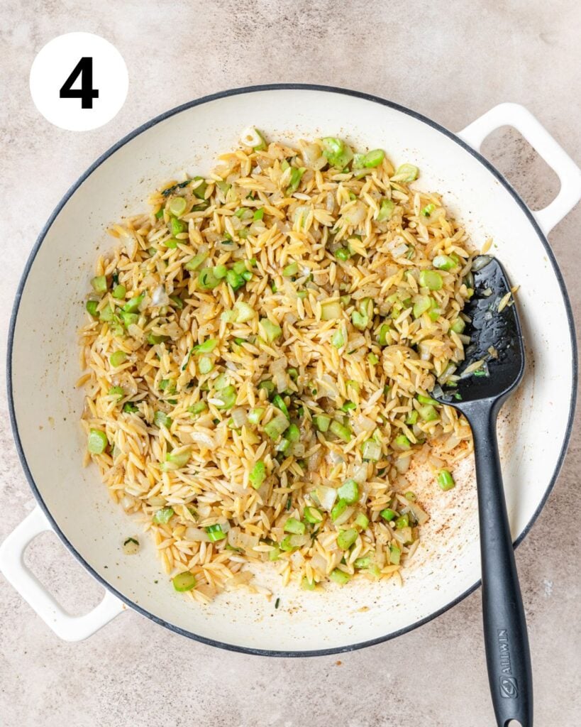 adding orzo to toast in pan.