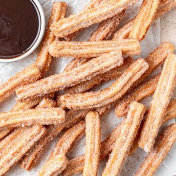 close up of homemade churros with chocolate sauce.