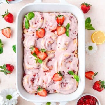 strawberry mint cinnamon rolls topped with sliced strawberries.