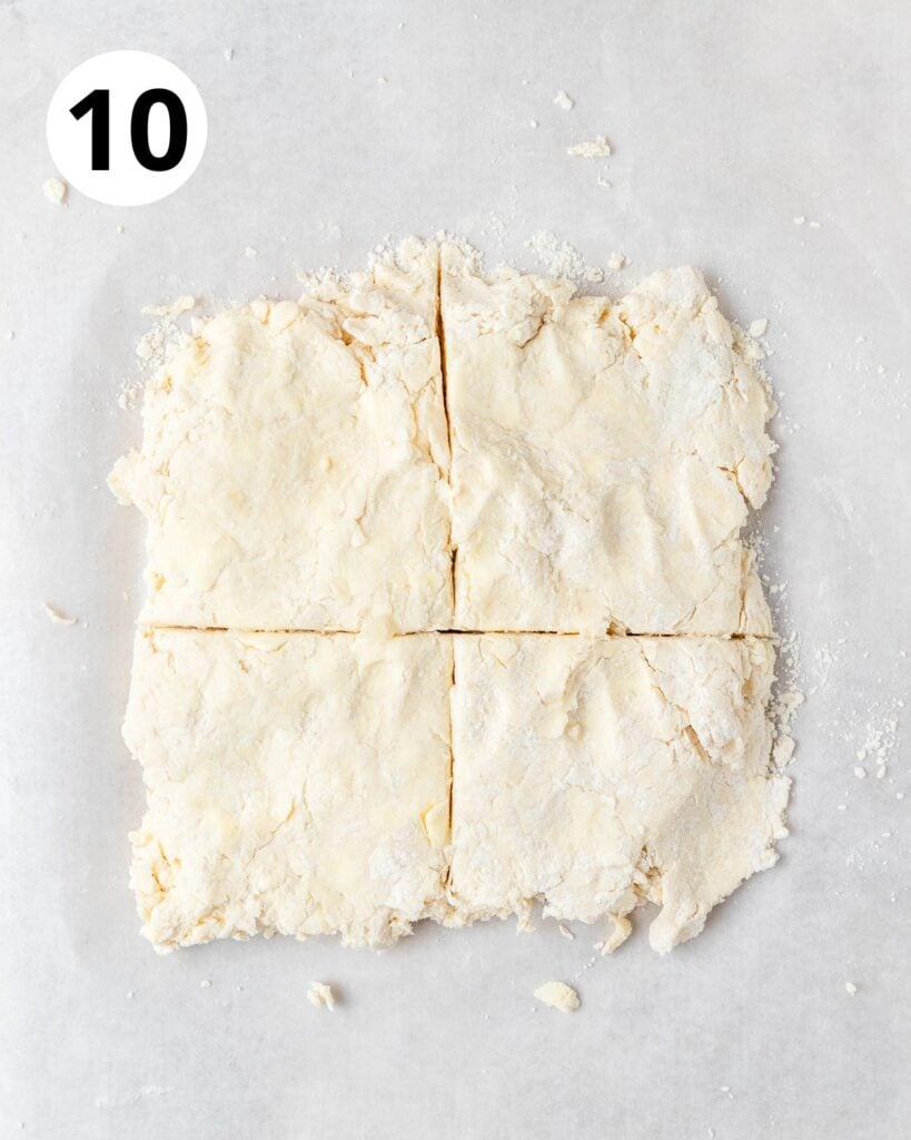 cutting biscuit dough into 4 squares.