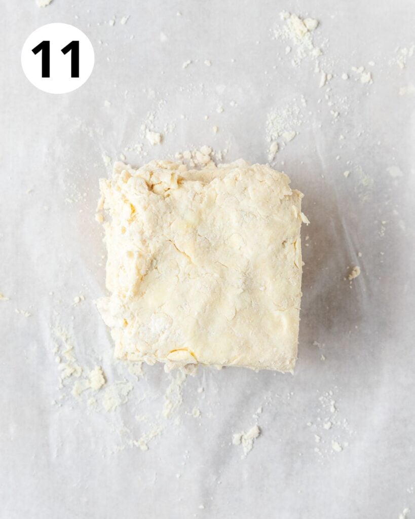 stacking squares of biscuit dough on top of each other.
