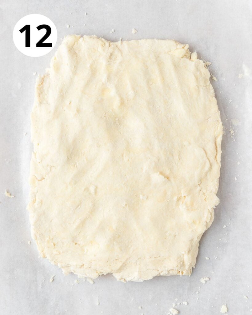 patting sourdough biscuit dough into large rectangle.