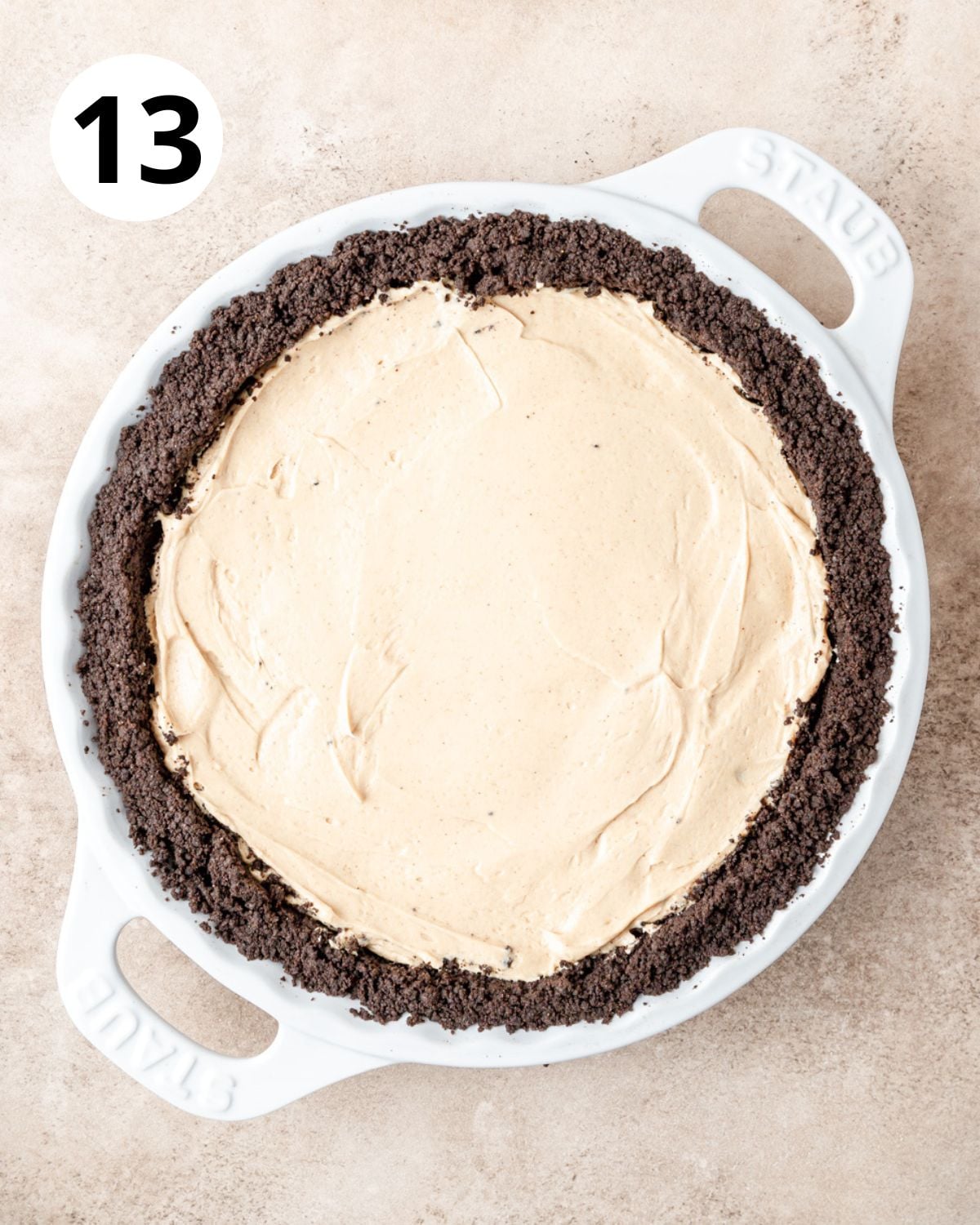adding peanut butter pie filling to cooled oreo crust.