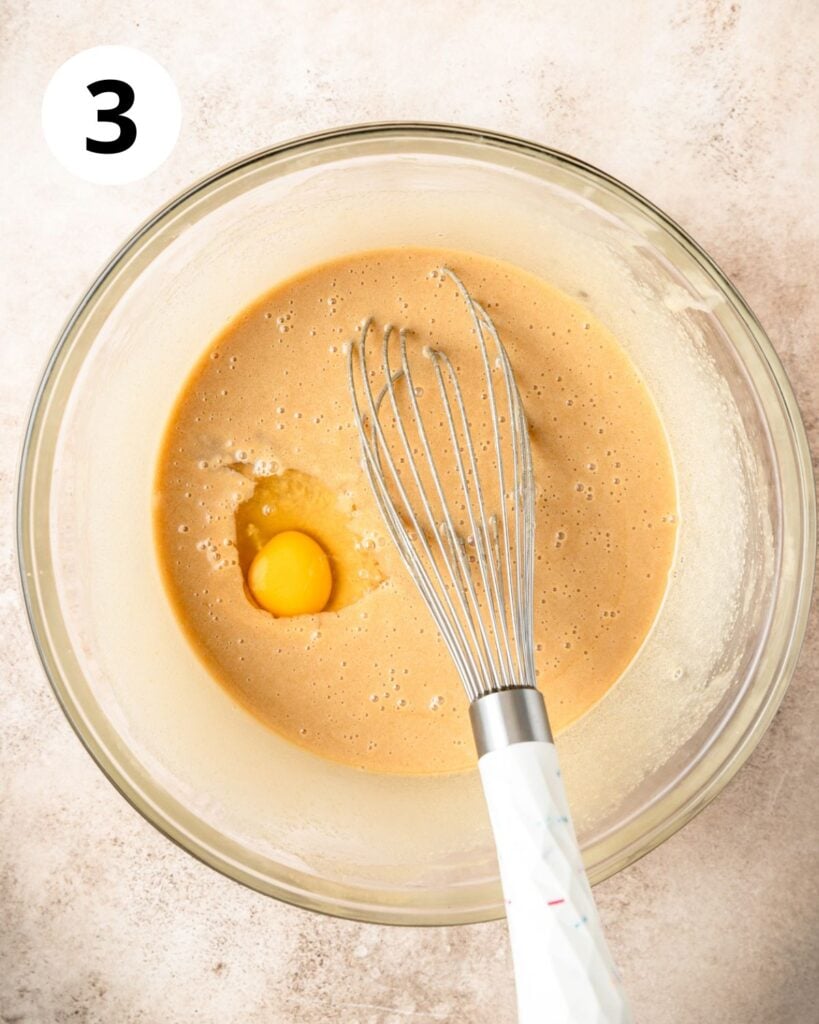 adding eggs to batter one at a time.