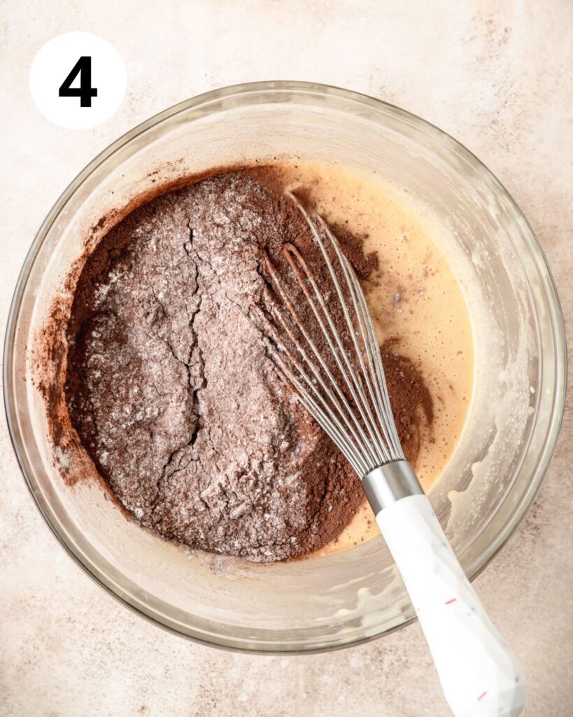 adding dry ingredients to brownie batter.