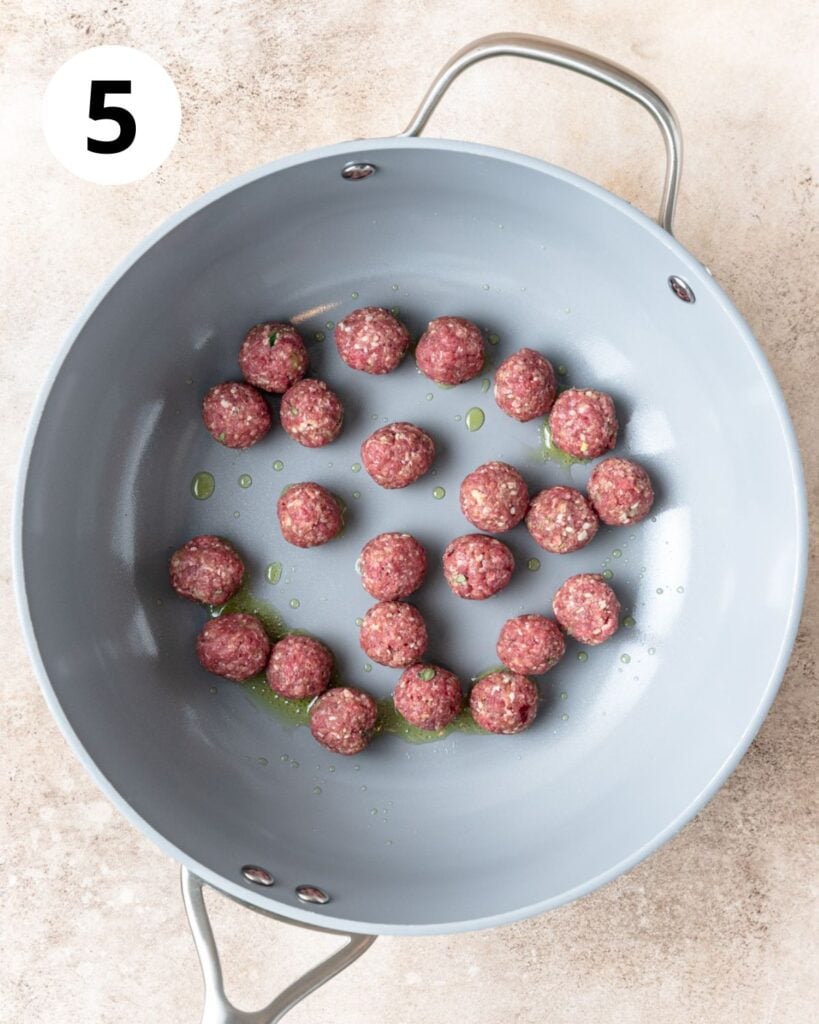 searing mini meatballs in batches.