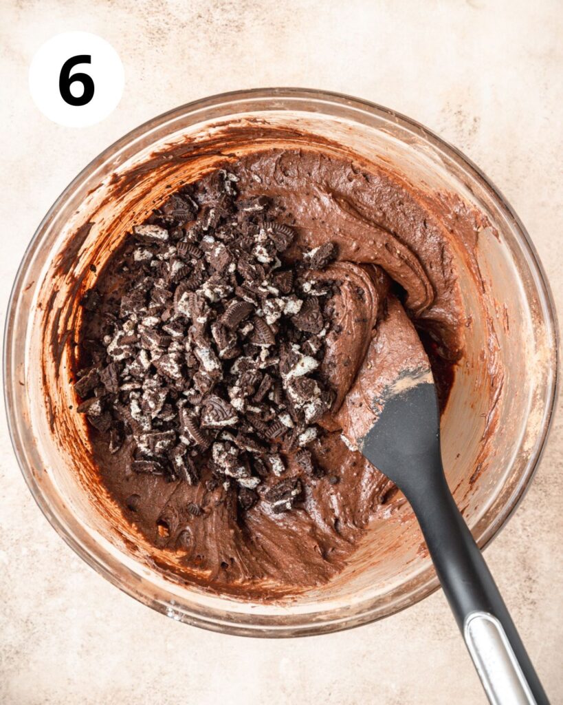 adding chopped Oreos to brownie batter.