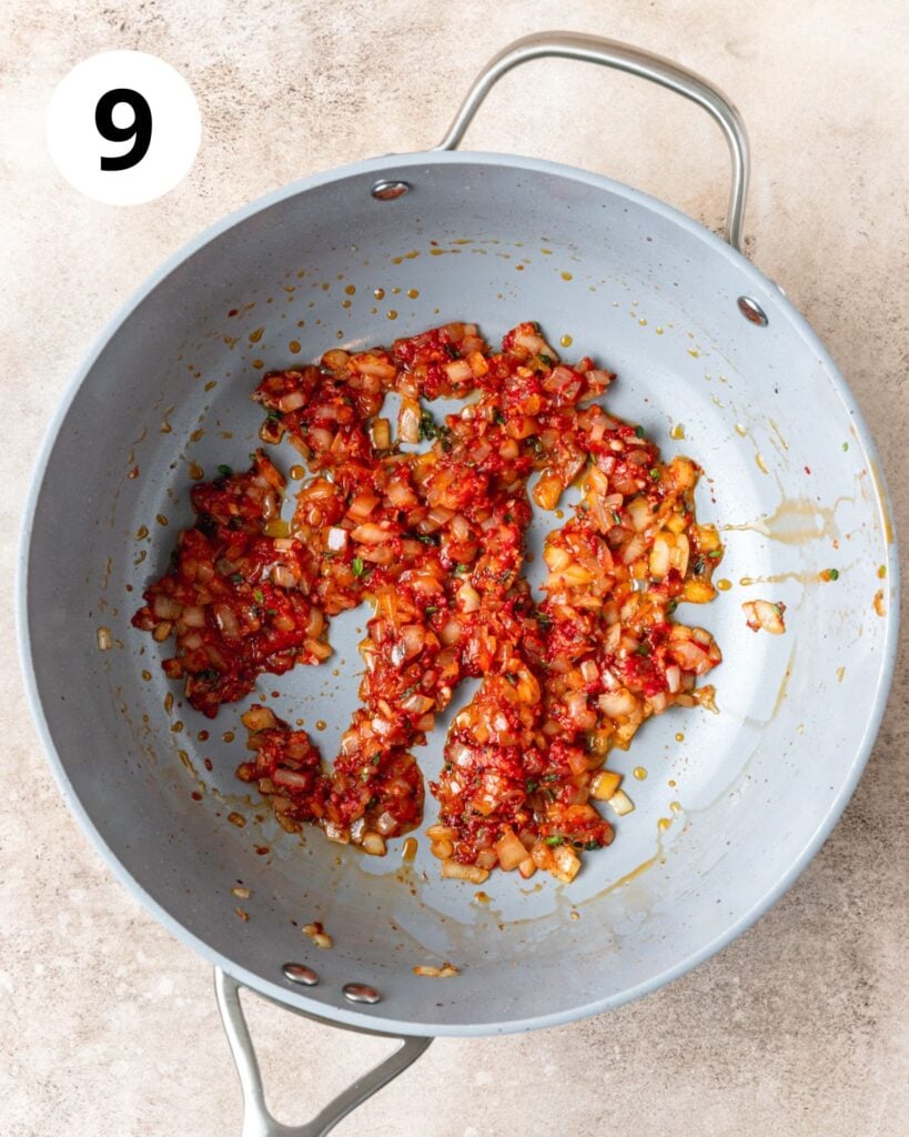 adding tomato paste to onions.