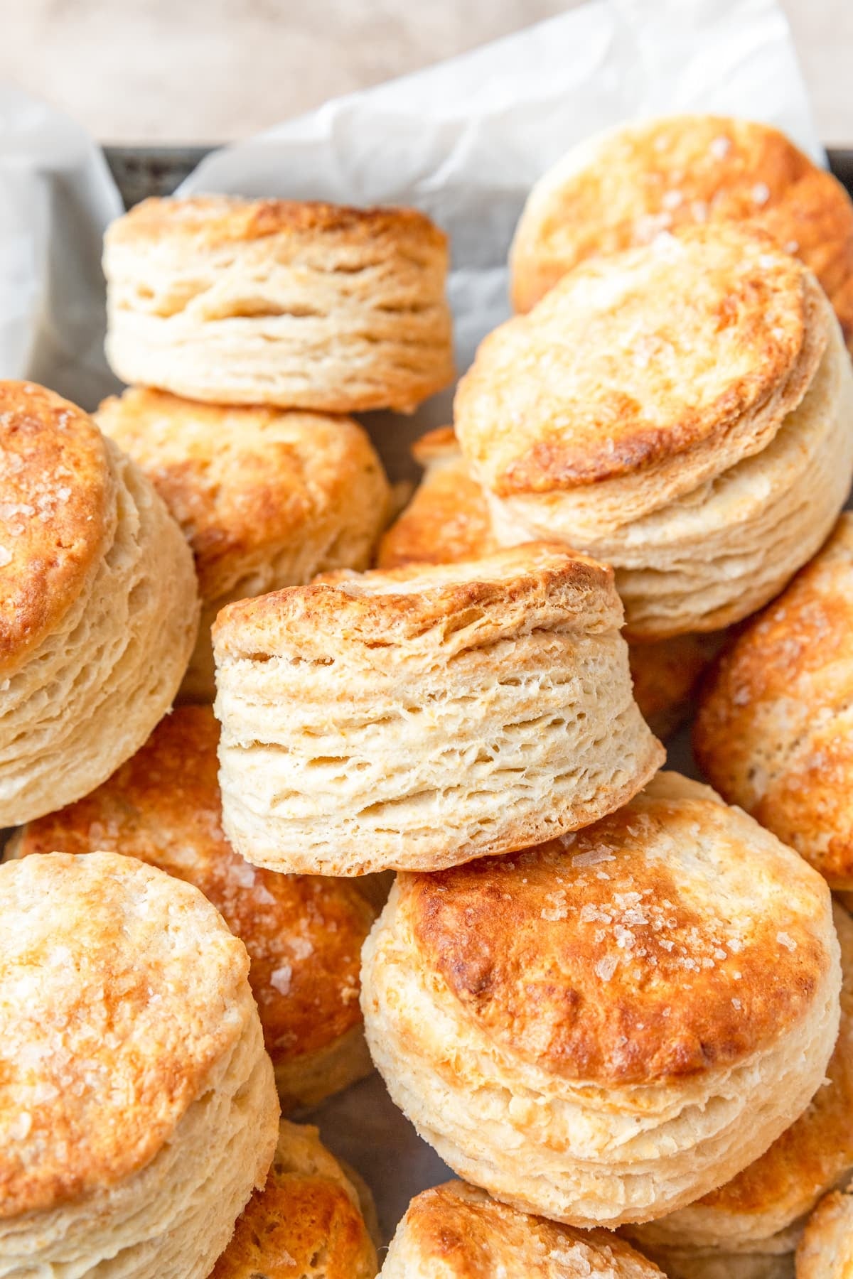 basket of flaky sourdough discard buttermilk biscuits.