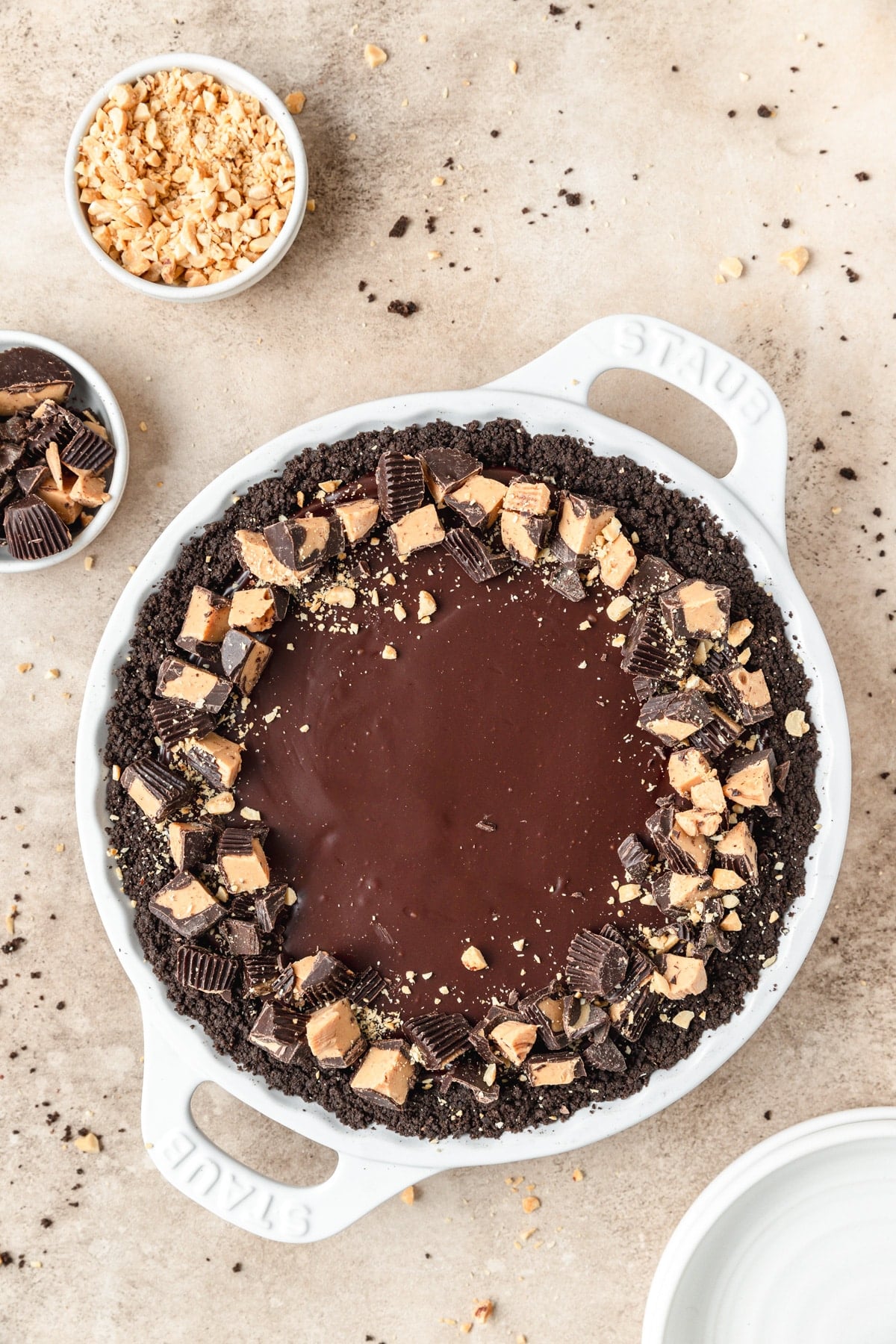 chocolate peanut butter pie with chopped peanut butter cups on top.