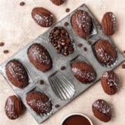 close up of dark chocolate espresso madeleines with flaky sea salt.