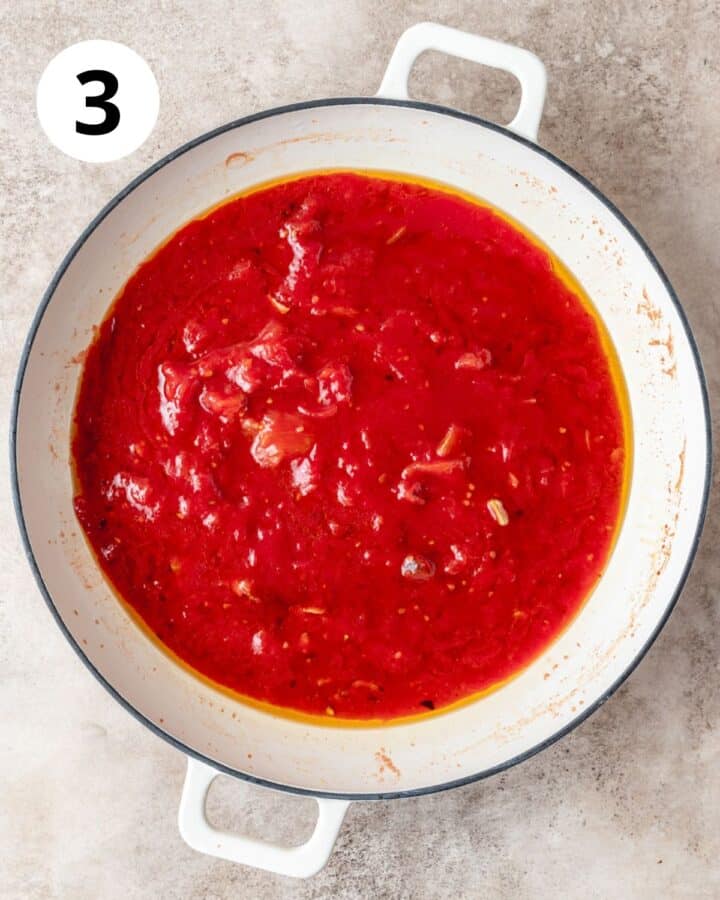 adding crushed san marzano tomatoes to pot.