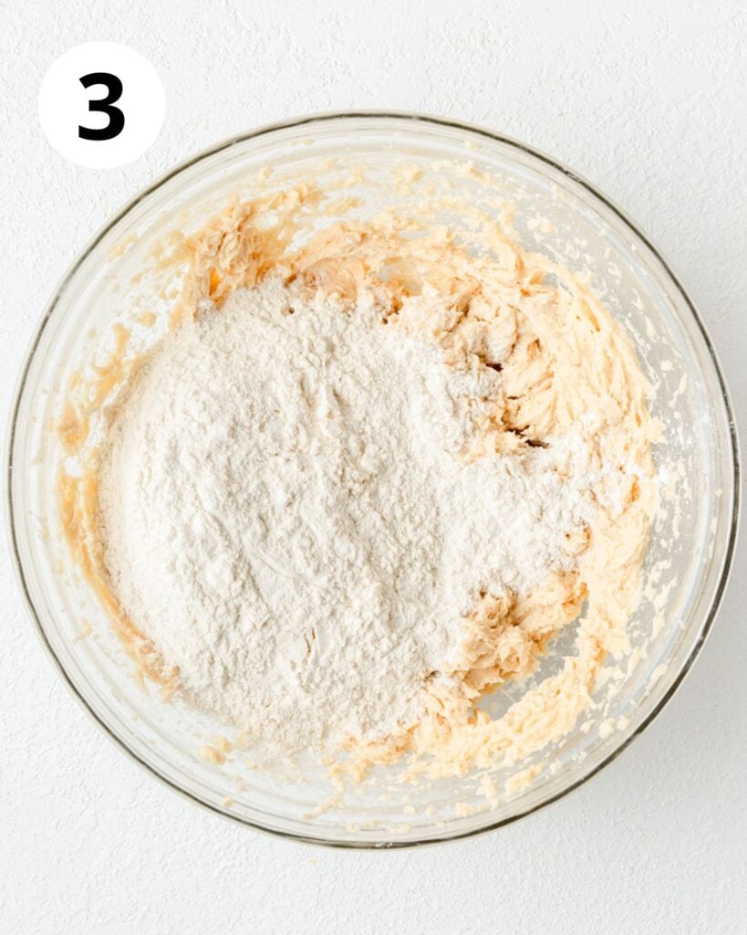 adding dry ingredients to cookie dough.