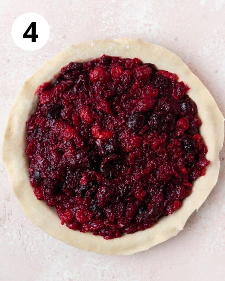 adding precooked cherry filling to pie shell.