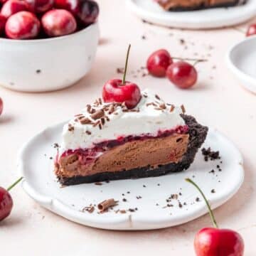 slice of Black Forest pie with cherry sauce and whipped cream.