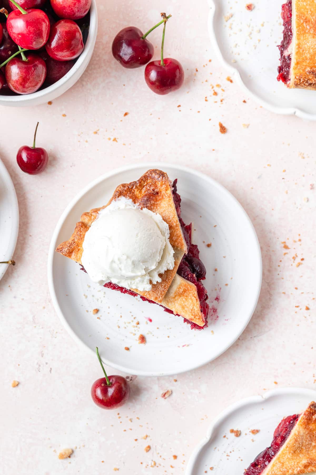 slice of cherry pie with scoop of vanilla ice cream.