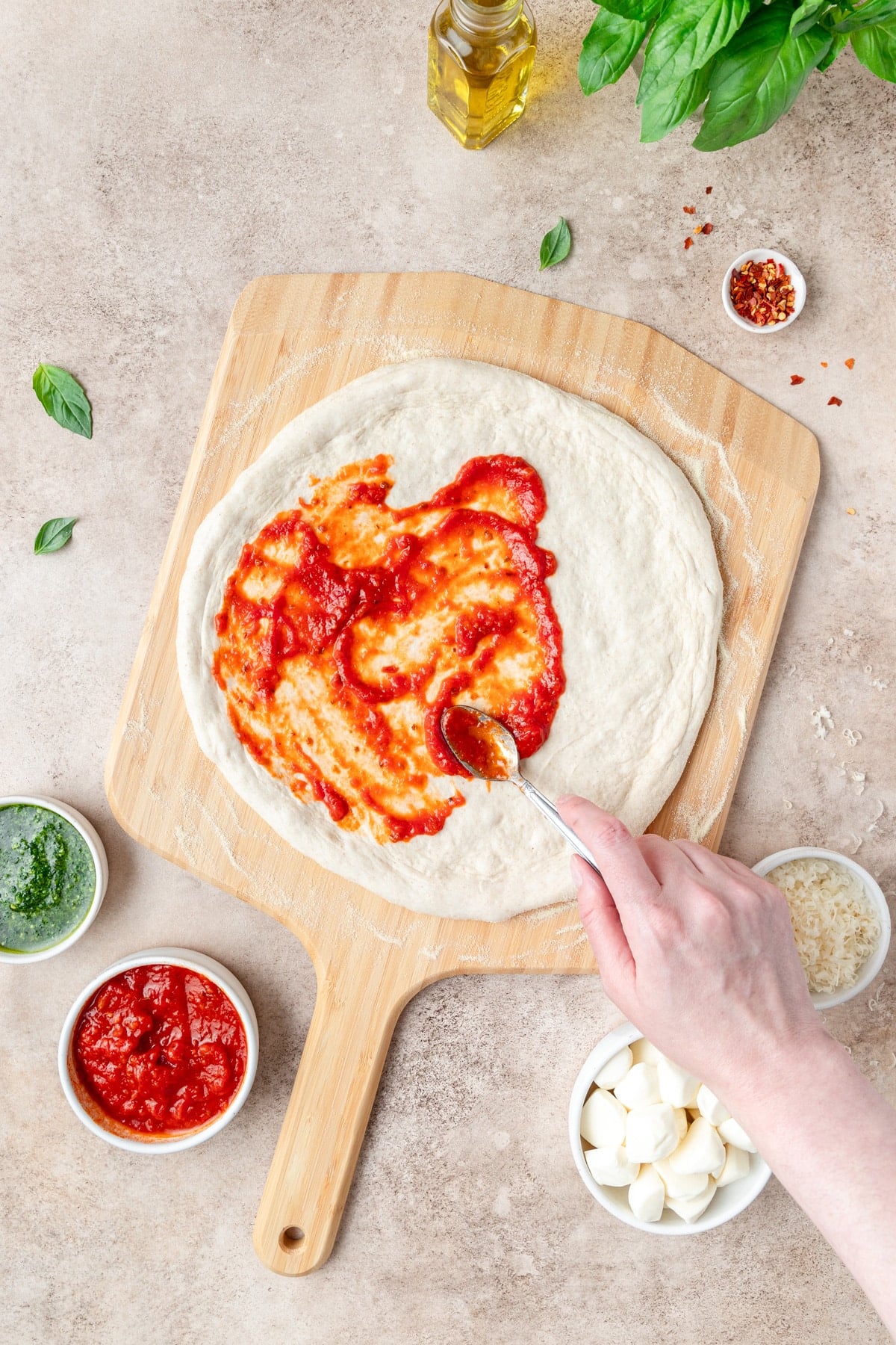 homemade pizza sauce spread on pizza dough.