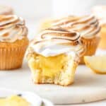 close up of lemon meringue cupcakes filled with lemon curd and topped with toasted meringue.