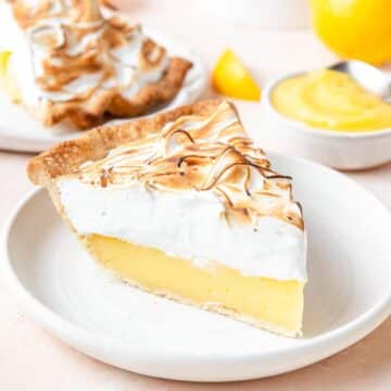 slice of lemon meringue pie with toasted Swiss meringue.