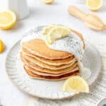 stack of sourdough lemon poppy seed pancakes with lemon glaze.