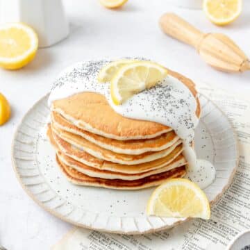stack of sourdough lemon poppy seed pancakes with lemon glaze.