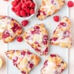 close up of raspberry sour cream scones with lemon glaze.