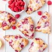 close up of raspberry sour cream scones with lemon glaze.