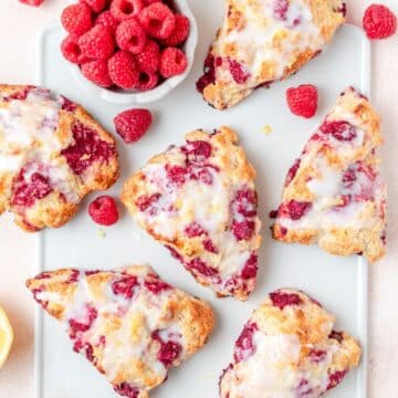 close up of raspberry sour cream scones with lemon glaze.