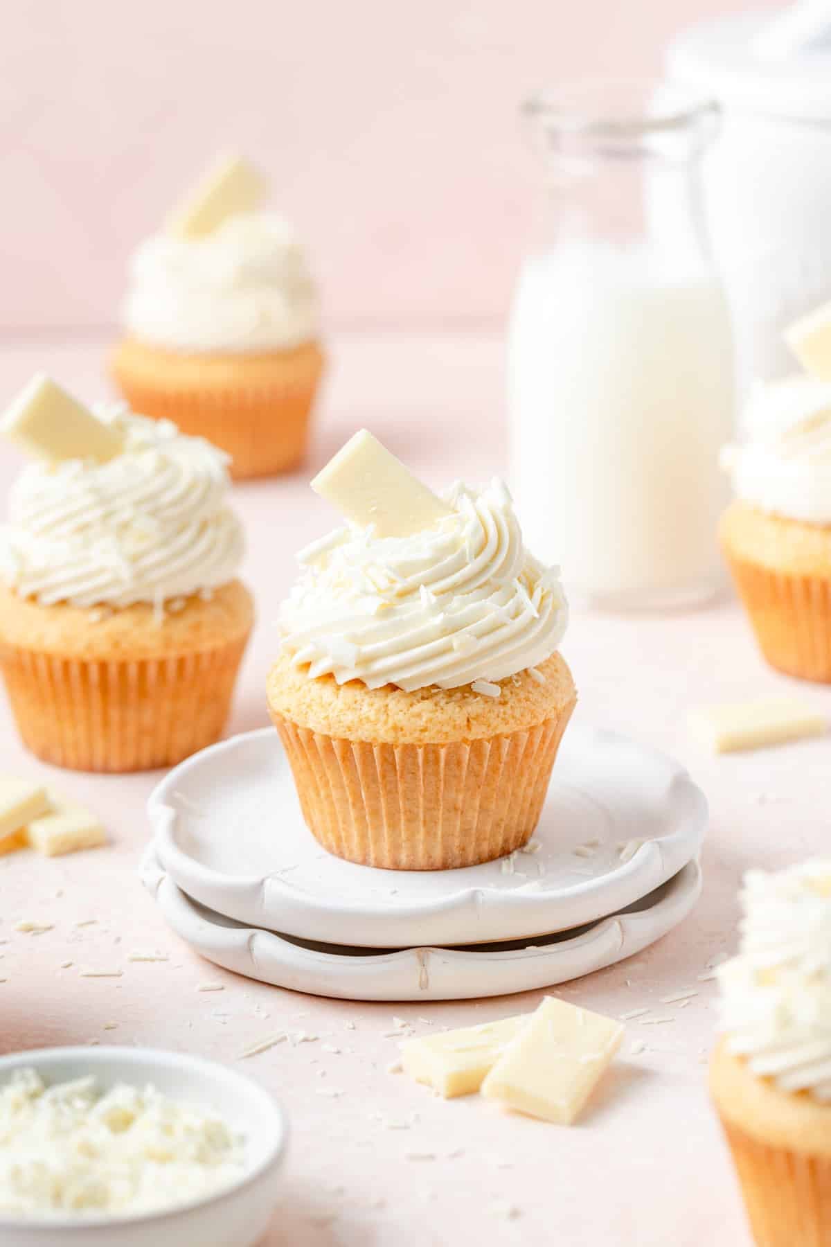 white chocolate cupcakes topped with white chocolate shavings. 