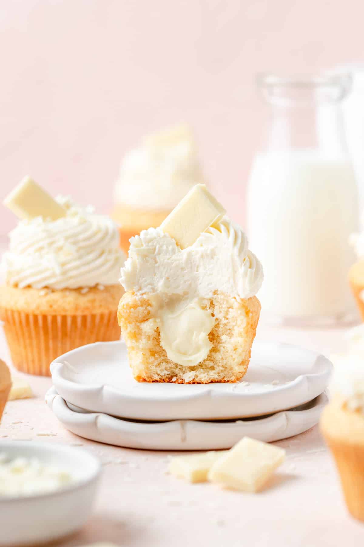 white chocolate cupcakes with bite taken out to see white chocolate ganache. 