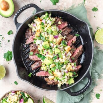 grilled flank steak topped with grilled corn avocado salsa.