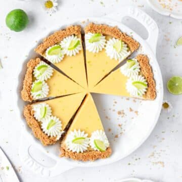 homemade key lime pie with graham cracker crust and topped with whipped cream.