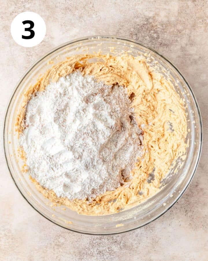 adding flour to shortbread dough.