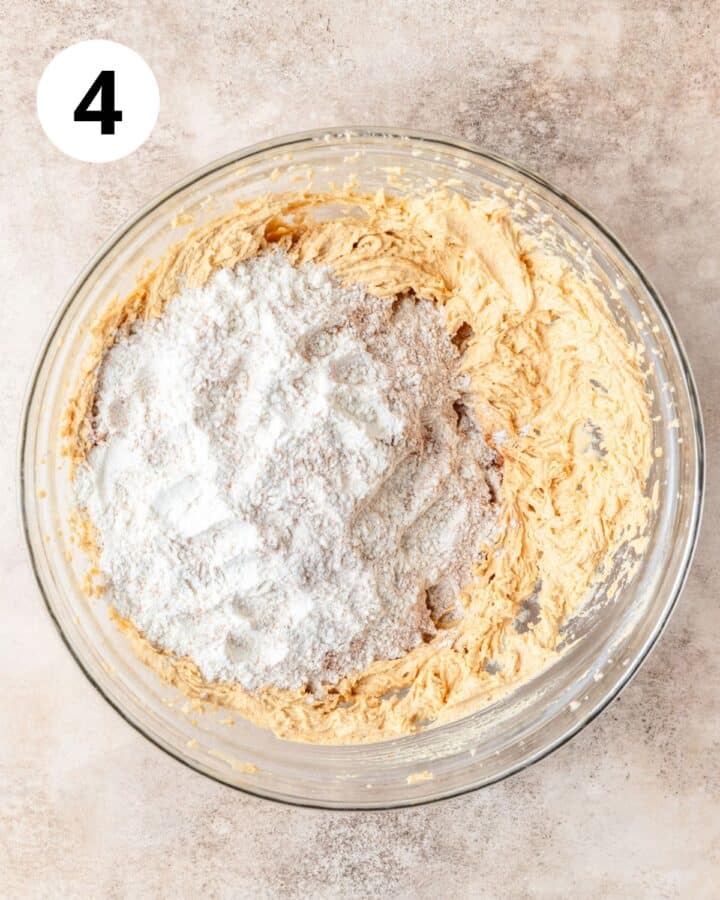 adding dry ingredients to cookie dough.