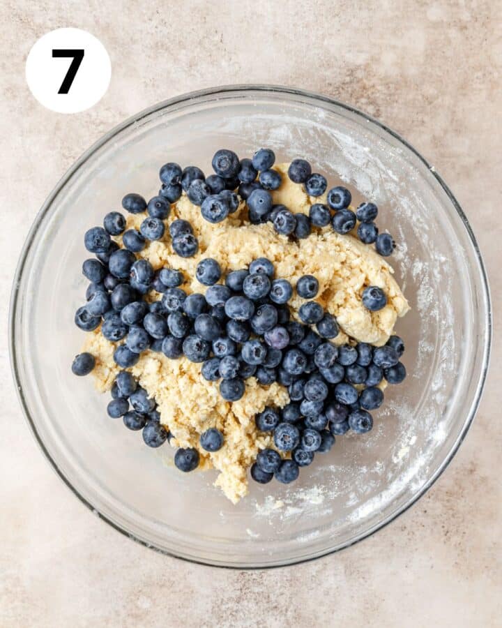 adding flash frozen blueberries to dough.