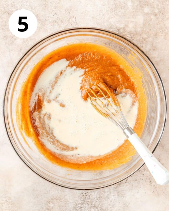 adding evaporated milk to pumpkin filling.