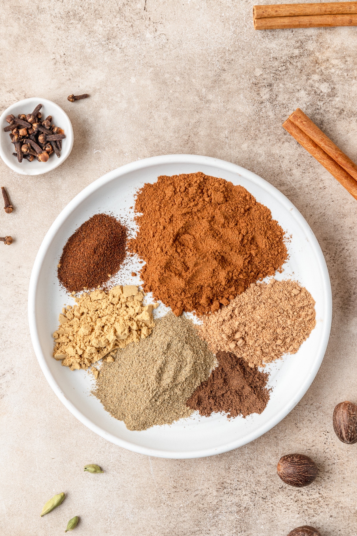 chai spice mix ingredients on plate.