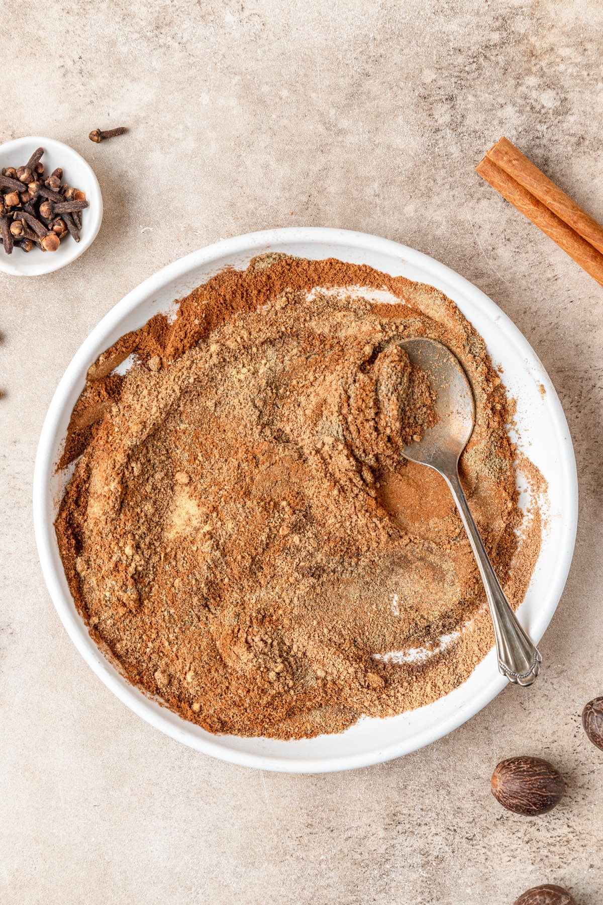 chai spice mix being mixed together.