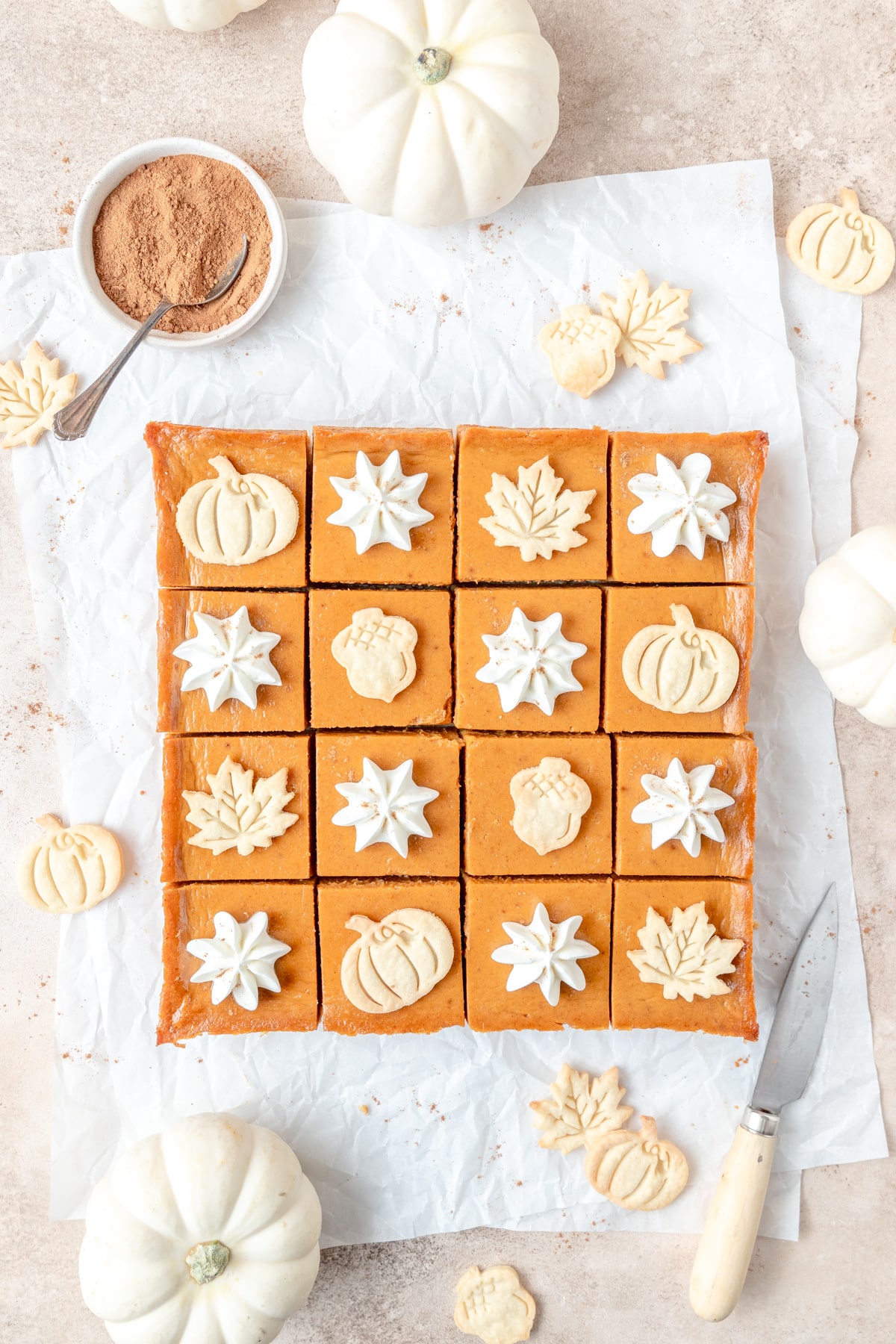 pumpkin pie bars with leaf cutouts on top.