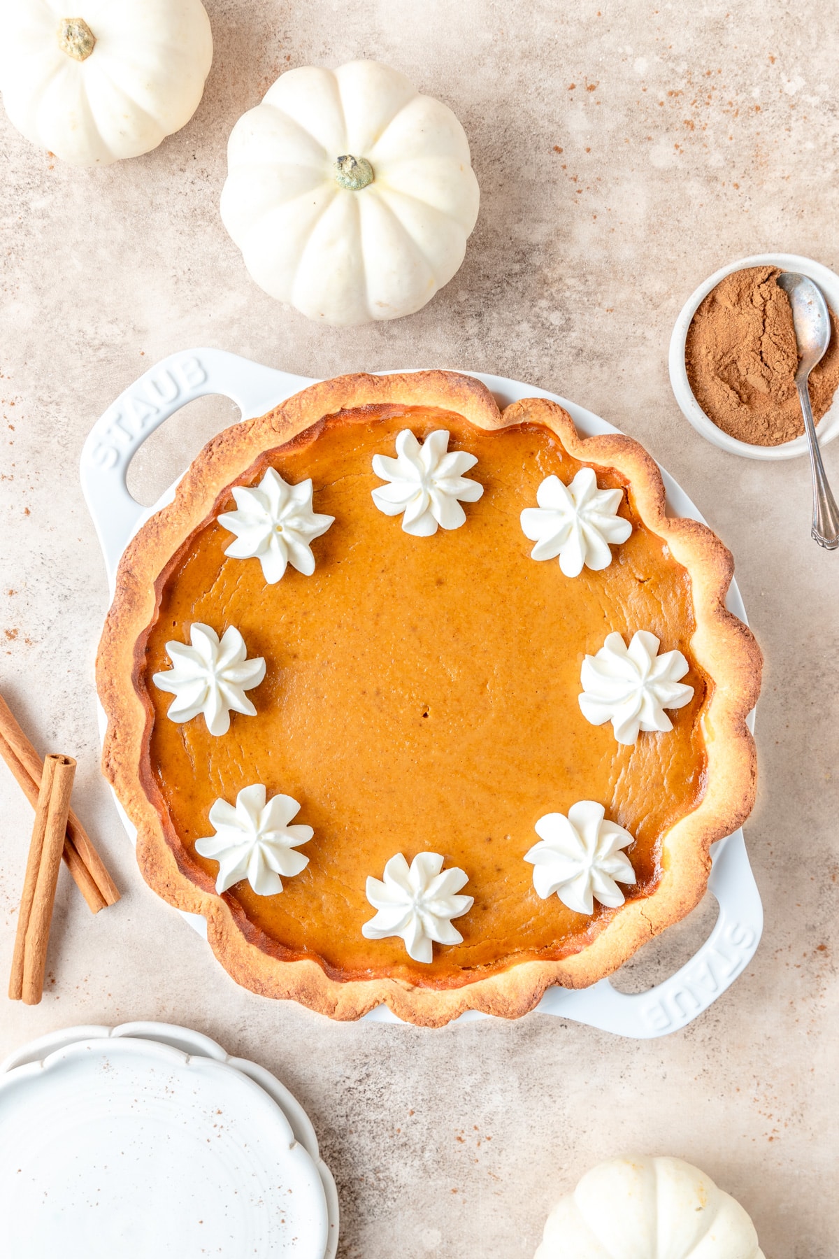 bourbon pumpkin pie topped with whipped cream.