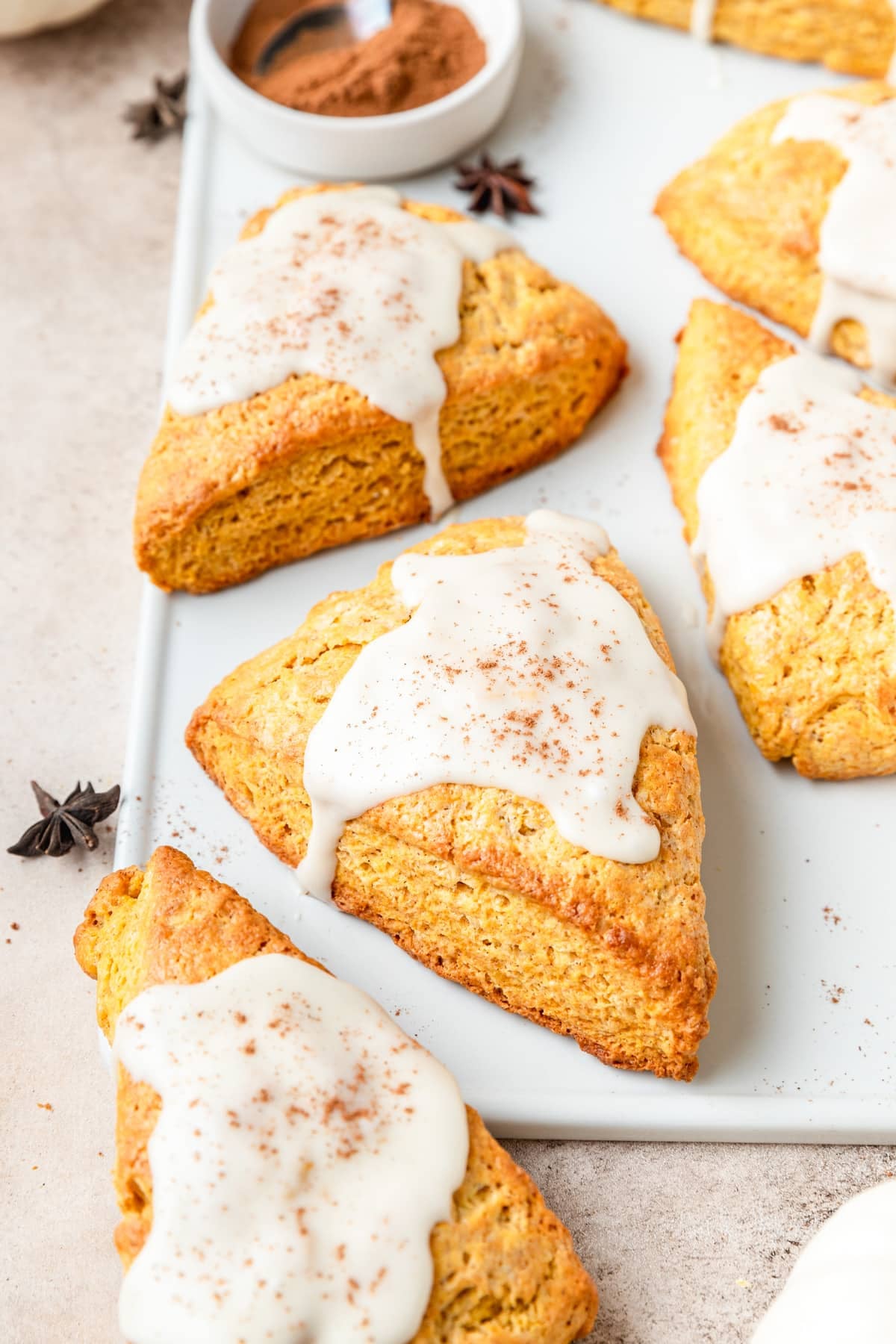 flaky pumpkin scones topped with maple glaze.