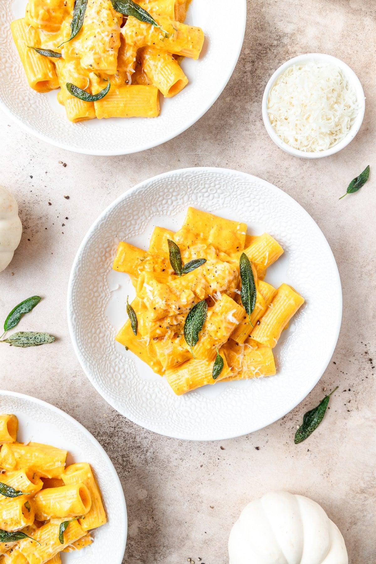 bowls of pumpkin vodka sauce pasta topped with crispy sage.