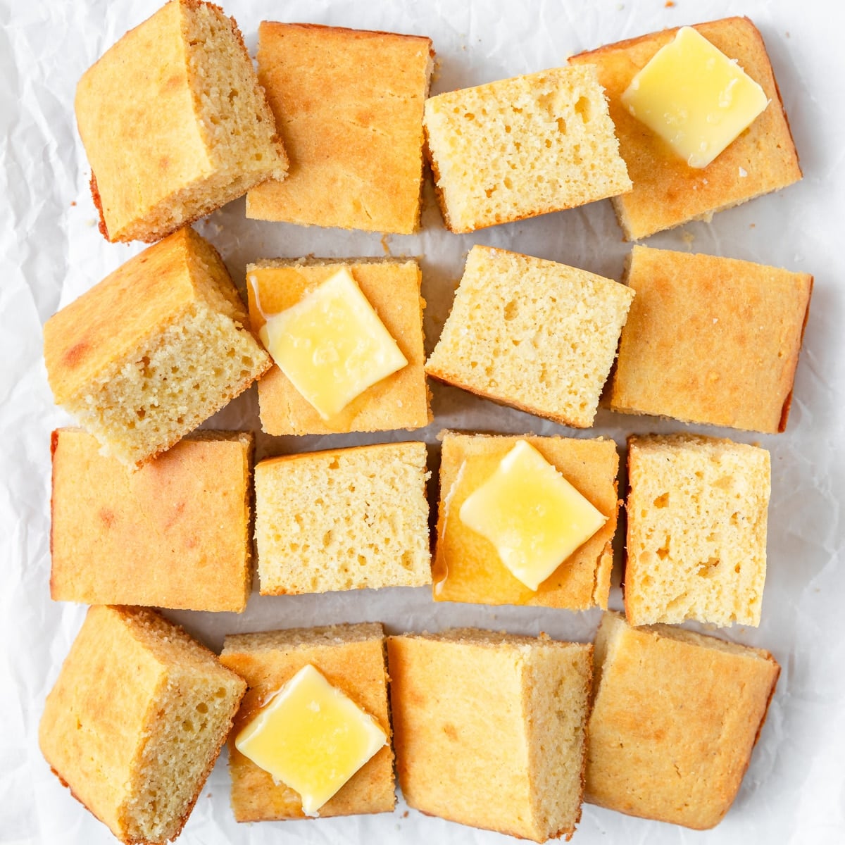 sourdough cornbread topped with pats of butter.