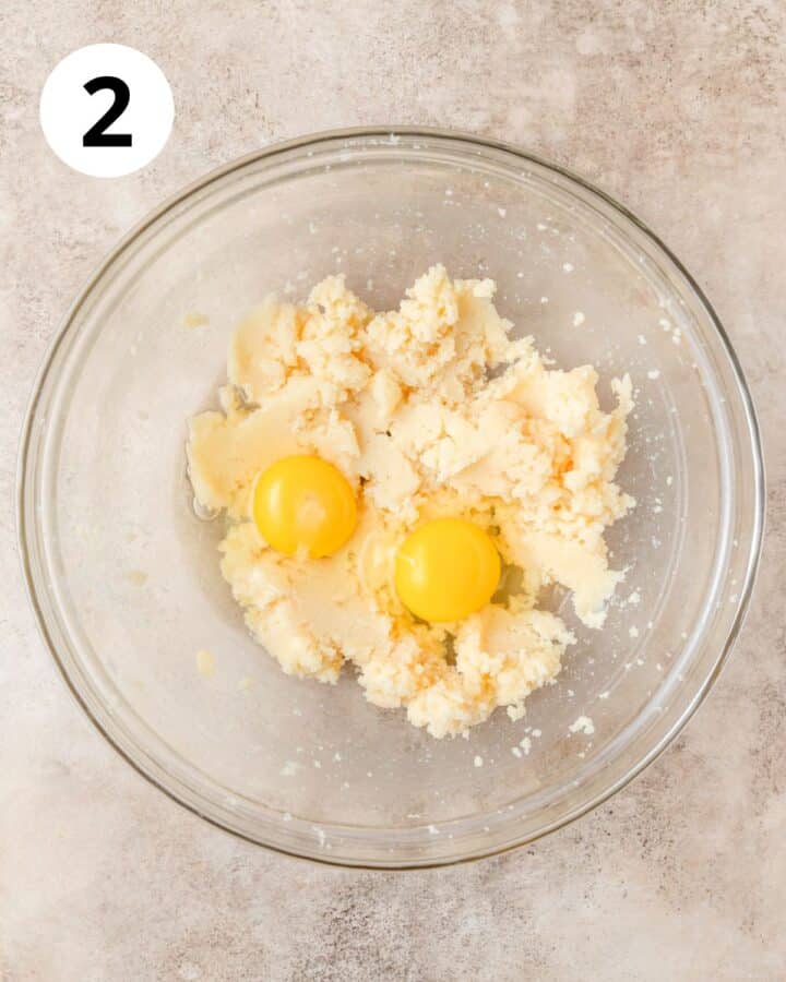adding eggs to dough.