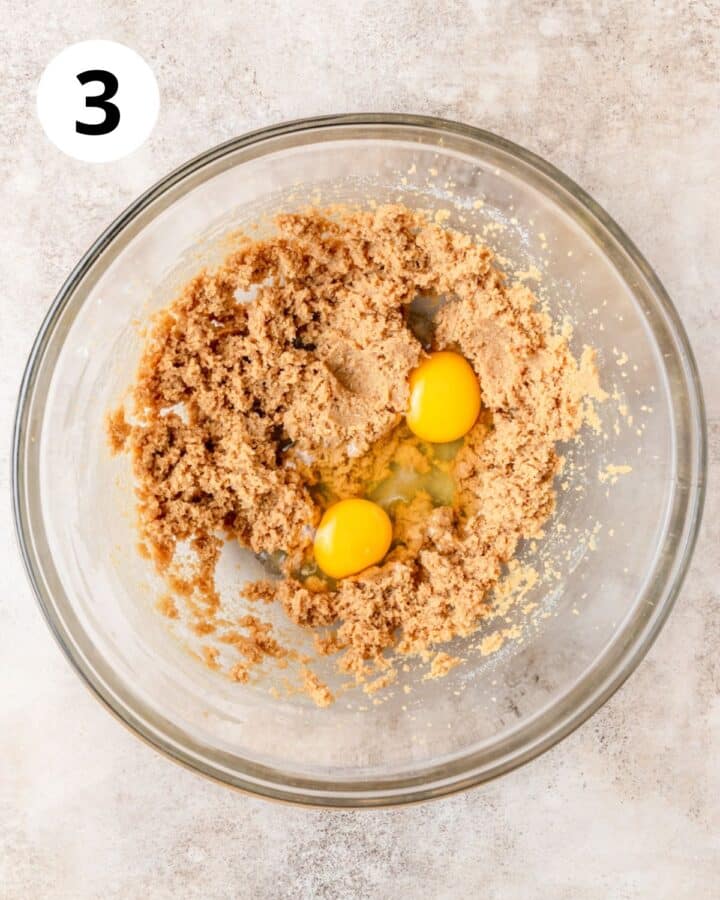 adding eggs to biscotti dough.