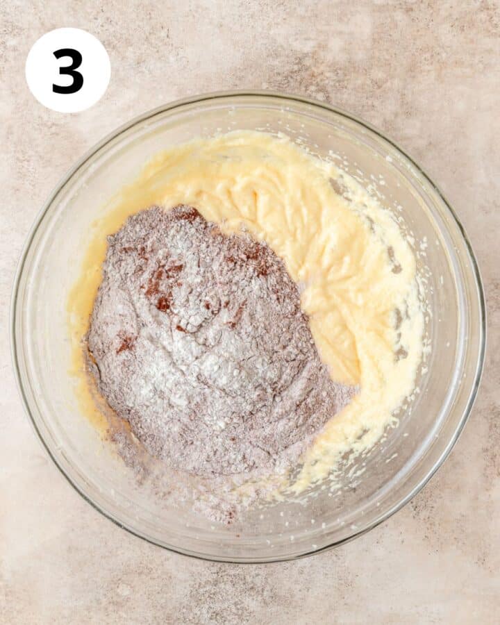 adding dry ingredients to dough.