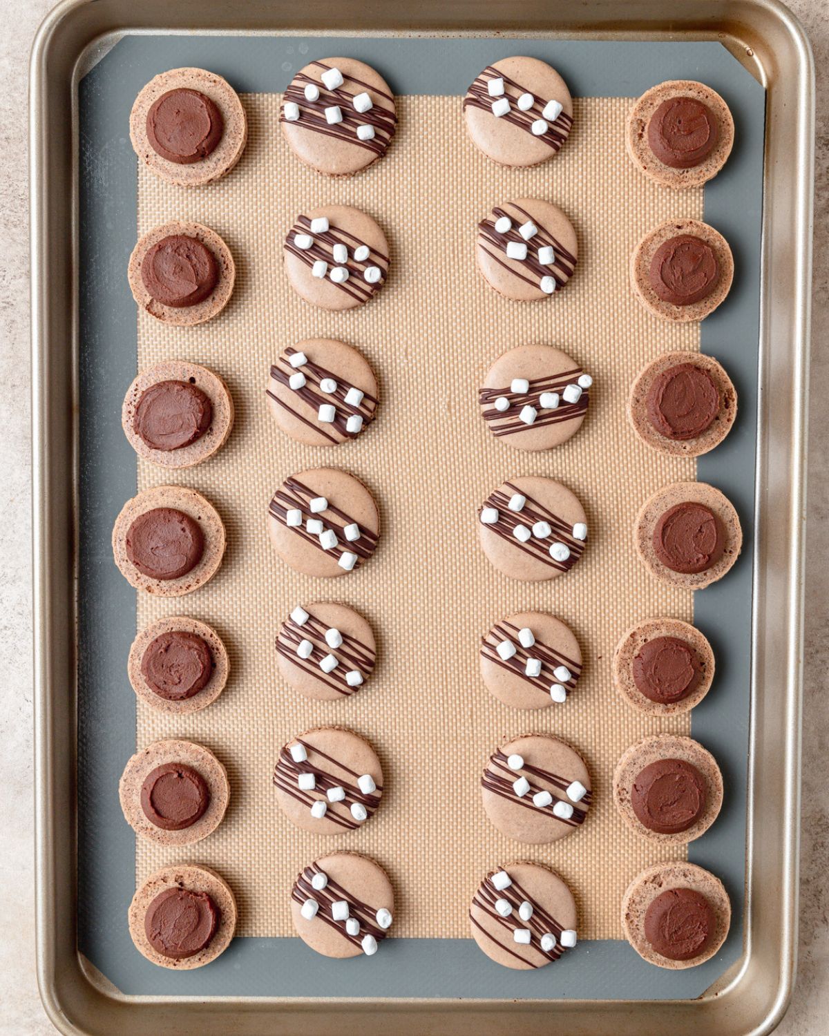 chocolate ganache piped onto bottom of macarons.