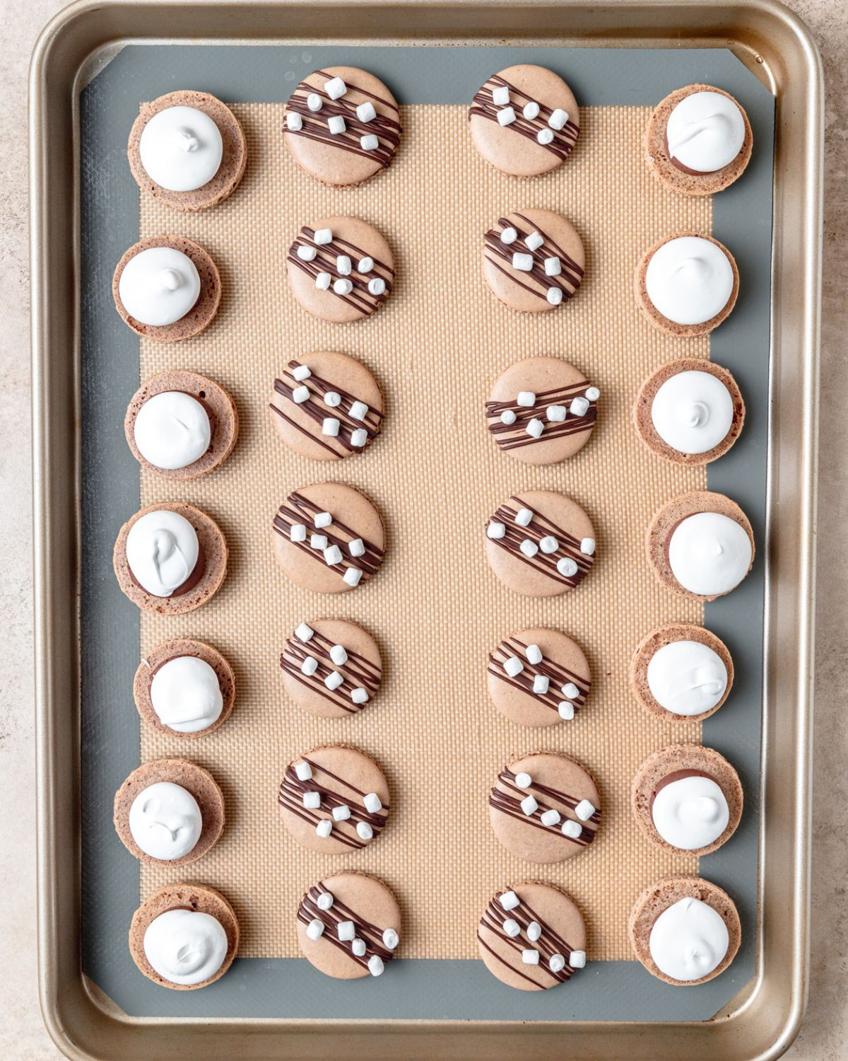 piping swiss meringue on top of chocolate ganache filling.