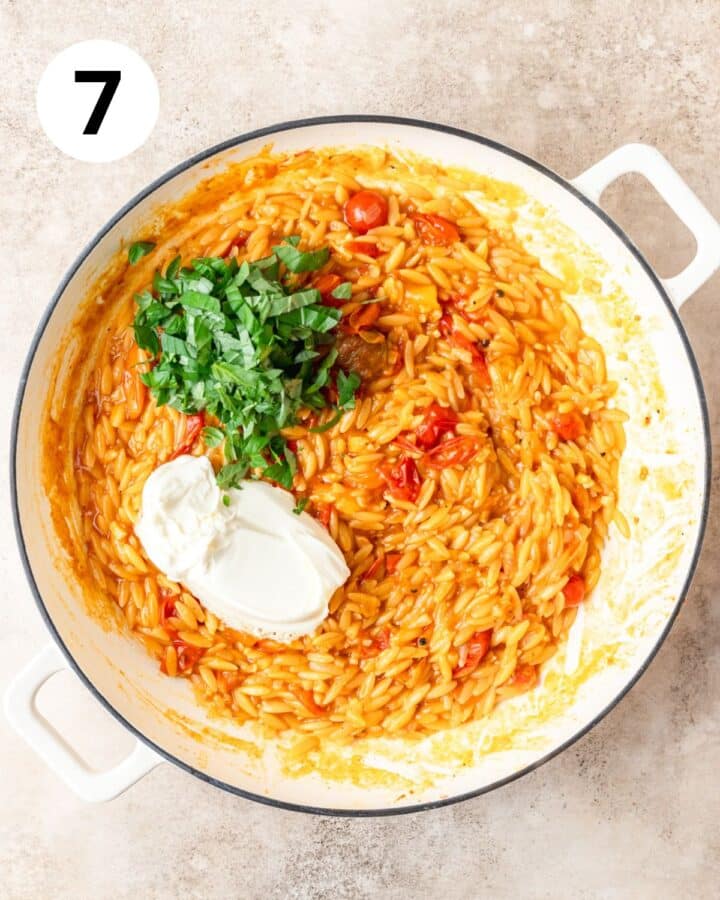 adding mascarpone and fresh basil to tomato orzo.